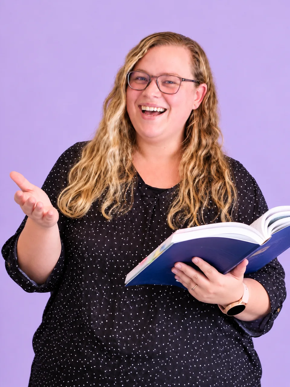 Monique Fourie smiling, holding an open textbook