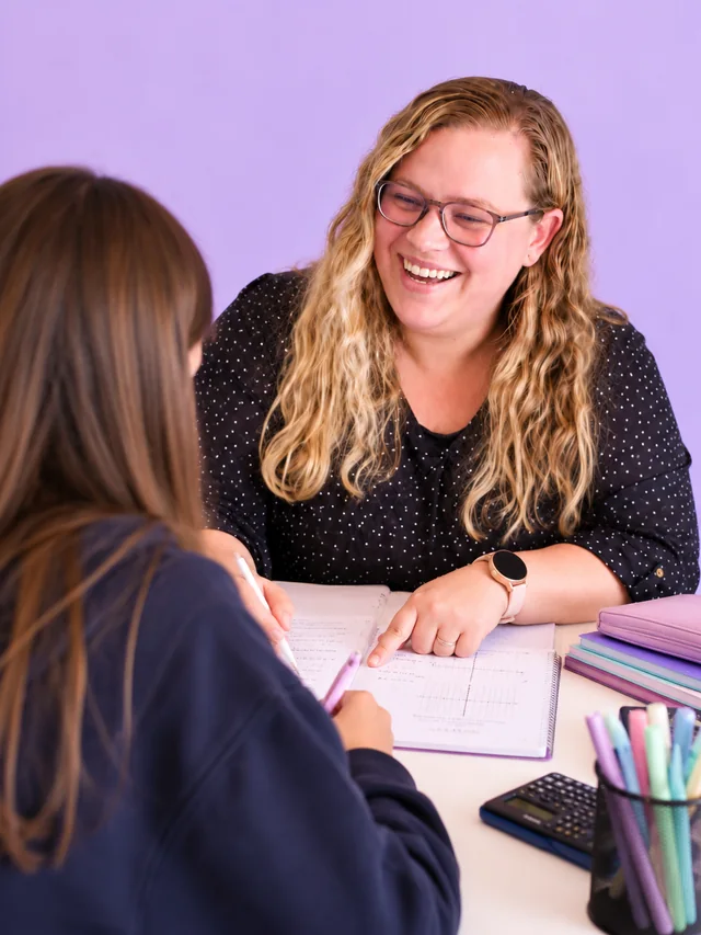 Monique Fourie going through a graph in a workbook with a learner during a lesson